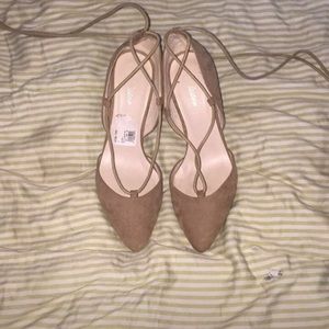 Pointed tan short heels with long ties.